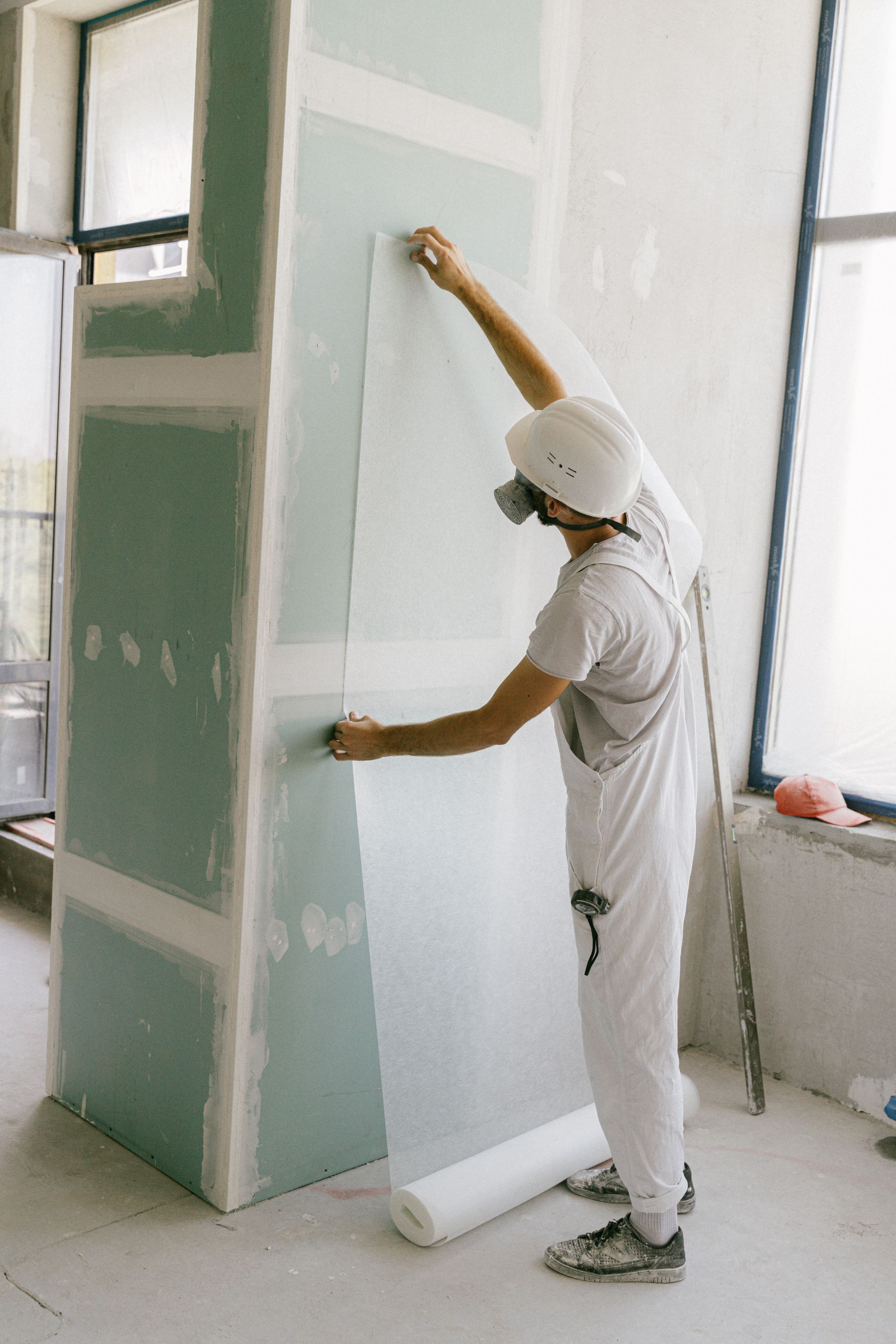 Installing a sheet of drywall on a residential wall
